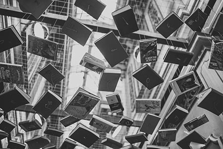 Grayscale Photo of Hanging Books, image courtesy of Pexels