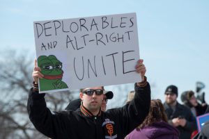 A white supremacist uses image of Pepe the Frog at a Trump rally in Minnesota (Fibonacci Blue via Flickr)